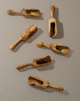 A collection of wooden scoops of various sizes, displayed against a neutral background.