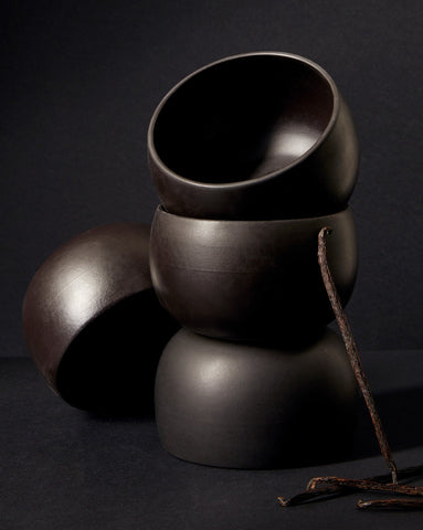 A stack of three white stoneware soup bowls of different sizes on a neutral background.