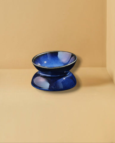 Blue ceramic bowl on a beige background