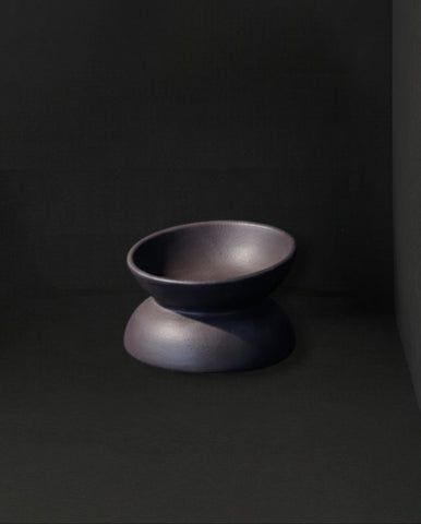 Dark gray ceramic bowl on a black background