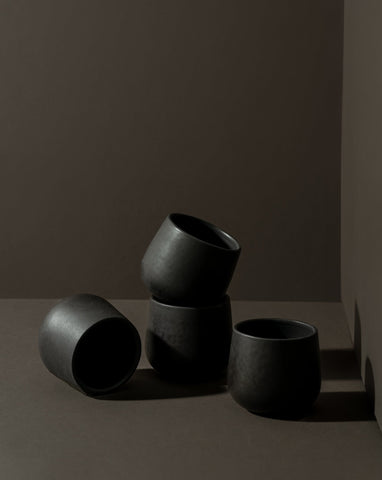 Three stoneware coffee cups in different sizes with a matte finish, displayed against a neutral background.