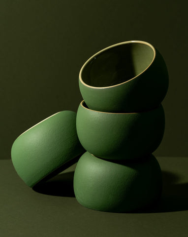 A stack of three white stoneware soup bowls of different sizes on a neutral background.
