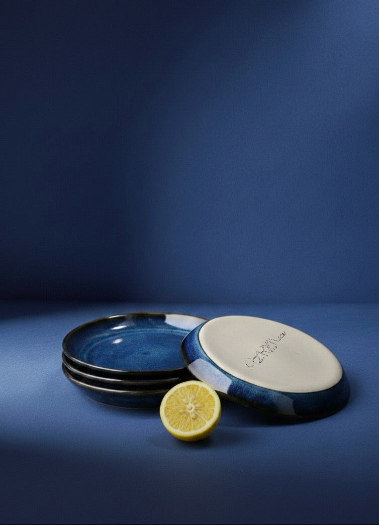 Set of ceramic plates with a lemon on a blue background